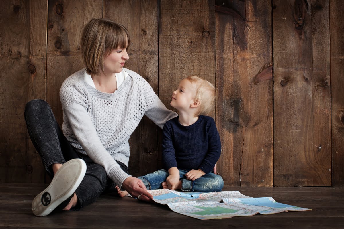a kid studying english speaking with his mother