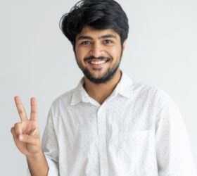 best-ielts-coaching-near-me happy student after finding ielts training center in noida city showing a sign of victory