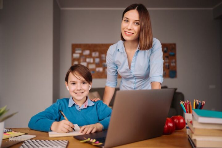 mother standing beside his kid who is taking english speaking classes for kids
